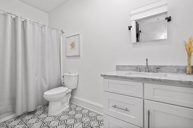 bathroom with tile patterned flooring, vanity, a shower with curtain, and toilet