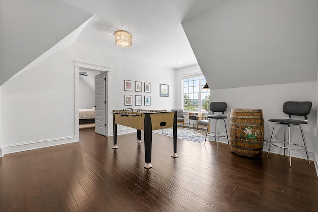 recreation room featuring lofted ceiling and dark hardwood / wood-style floors