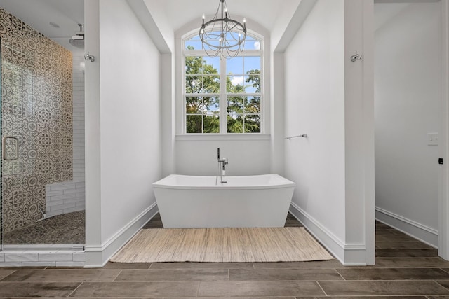 bathroom featuring lofted ceiling, plus walk in shower, and a notable chandelier