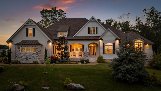 view of front of home with a yard and covered porch