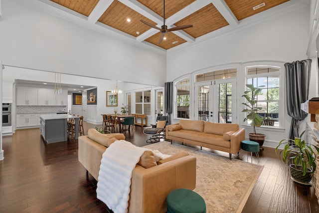 living room featuring dark hardwood / wood-style flooring, a towering ceiling, wooden ceiling, and french doors