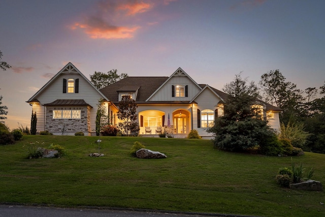 view of front of house featuring a porch and a lawn