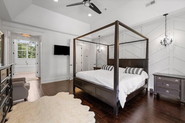 bedroom with dark wood-type flooring and ceiling fan with notable chandelier