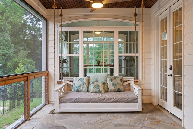 unfurnished sunroom featuring wood ceiling and french doors