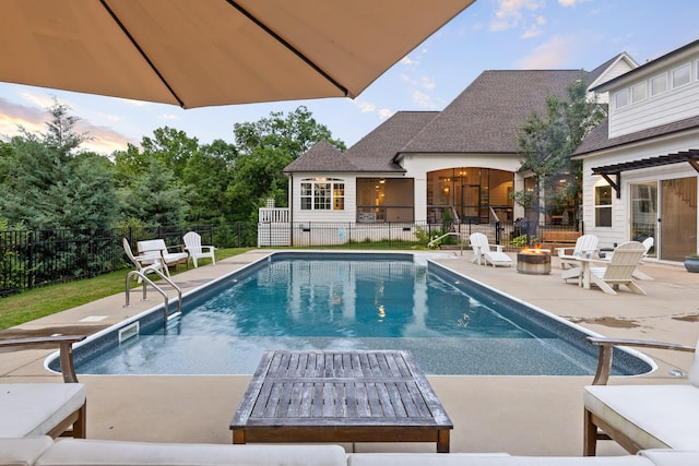 view of pool with an outdoor fire pit and a patio