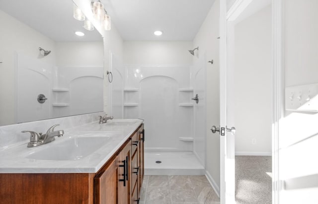 bathroom with a shower and vanity