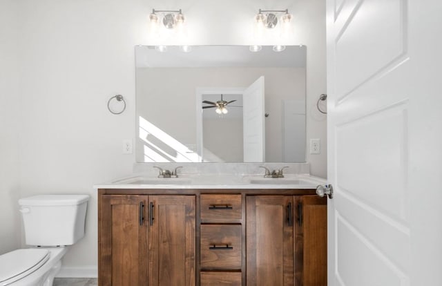 bathroom featuring vanity, ceiling fan, and toilet