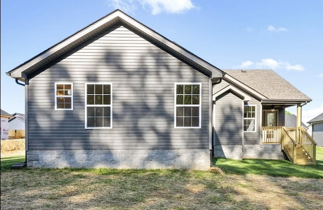 view of side of home with a yard