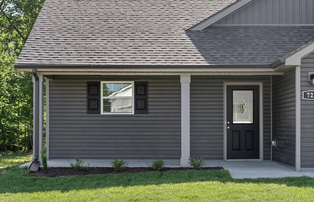 doorway to property featuring a lawn