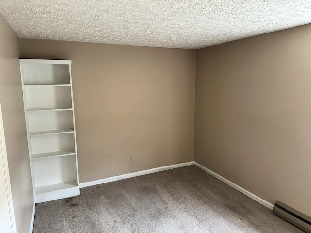 unfurnished room featuring carpet floors, a textured ceiling, and a baseboard heating unit