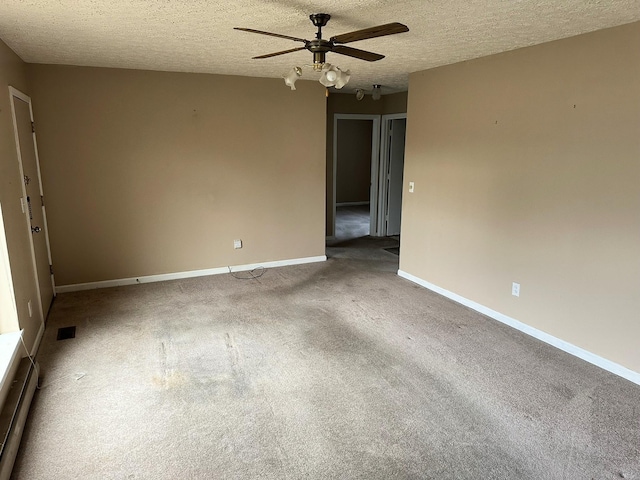 spare room with ceiling fan, carpet floors, and a textured ceiling