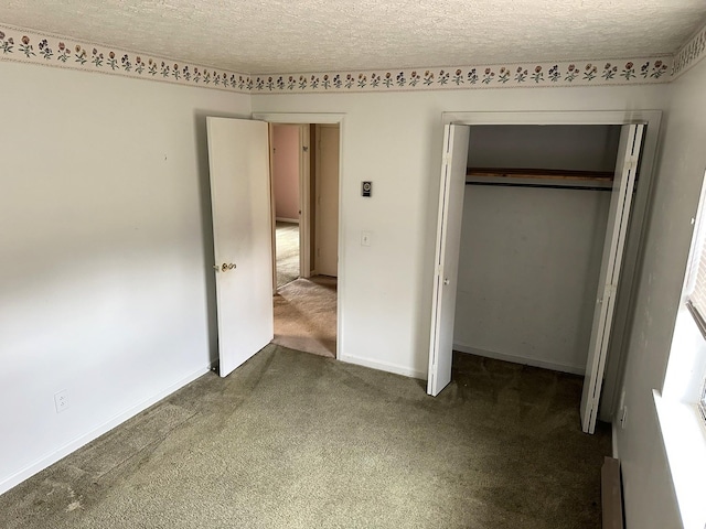 unfurnished bedroom with carpet floors, a textured ceiling, and a closet