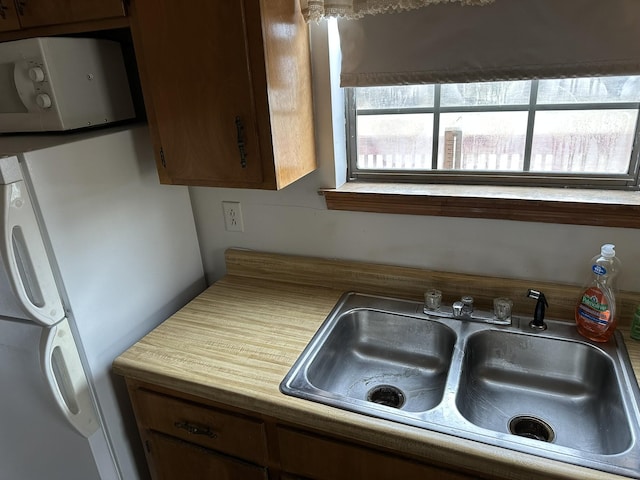 kitchen with white appliances and sink