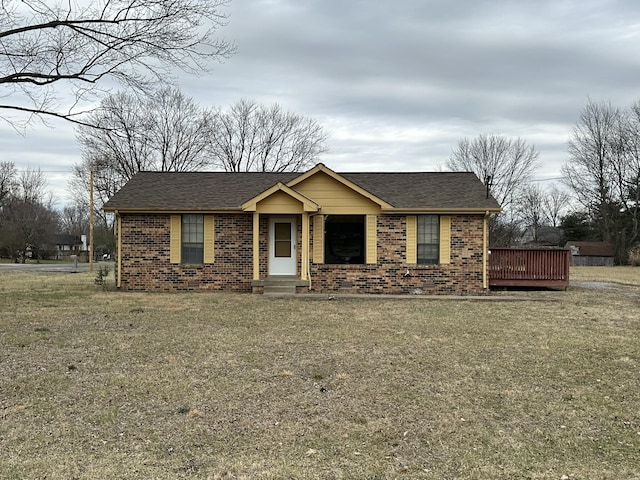 ranch-style home featuring a wooden deck and a front lawn