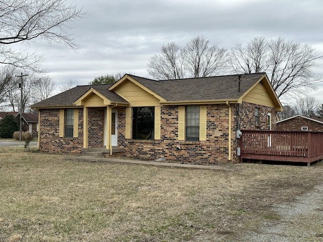 ranch-style home featuring a deck and a front lawn