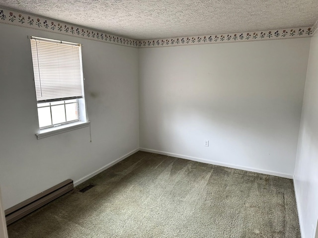 empty room with carpet flooring, a textured ceiling, and baseboard heating