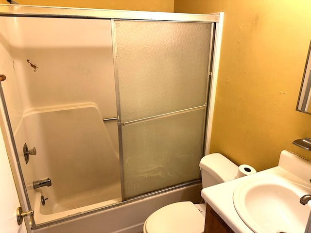 full bathroom with vanity, toilet, and combined bath / shower with glass door