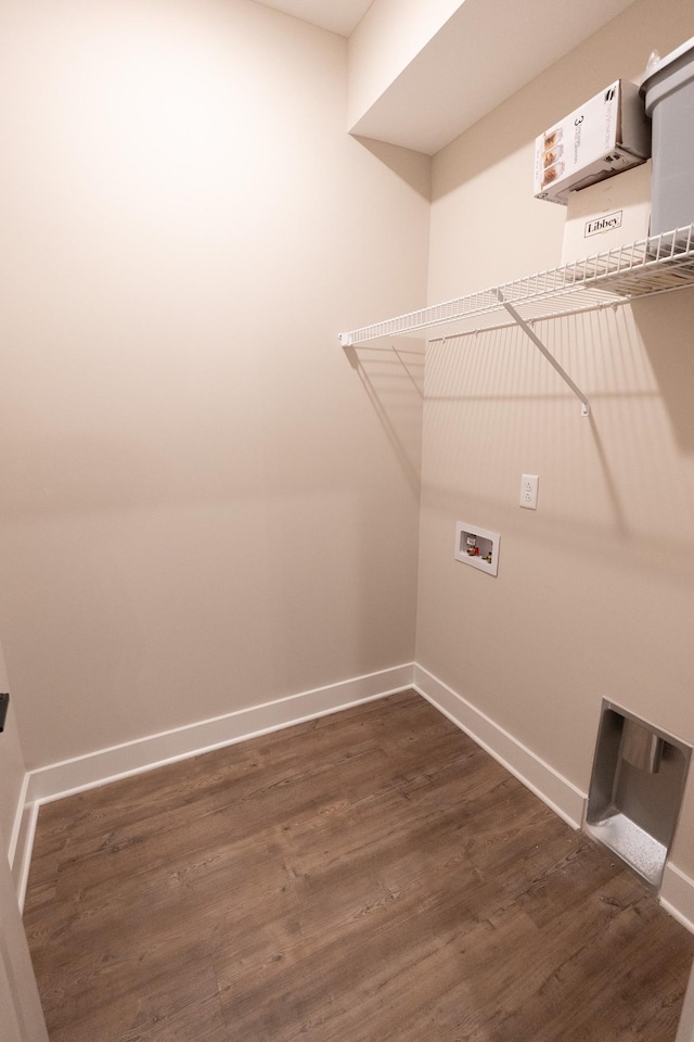 laundry area with dark wood-style floors, washer hookup, laundry area, and baseboards