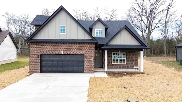 view of front of home featuring driveway, brick siding, and a shingled roof