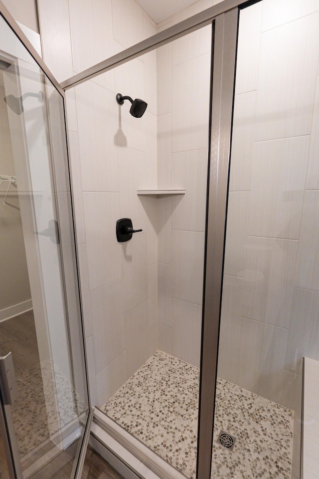 full bath with a spacious closet and a stall shower