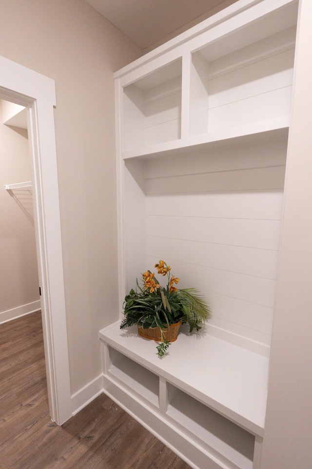 mudroom featuring dark wood-style flooring and baseboards