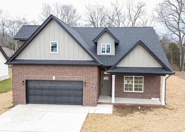 view of front of house featuring a garage, concrete driveway, brick siding, and roof with shingles