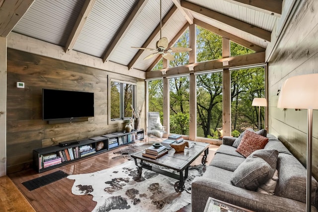 sunroom featuring ceiling fan and lofted ceiling with beams