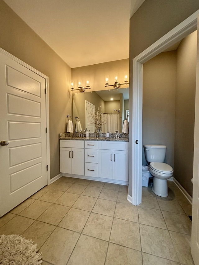 bathroom with vanity, toilet, and tile patterned flooring