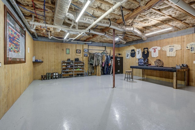 basement featuring wooden walls