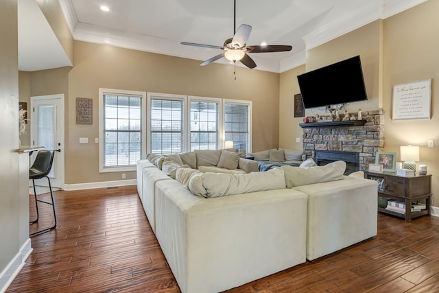 living room featuring crown molding, ceiling fan, a fireplace, and dark hardwood / wood-style flooring