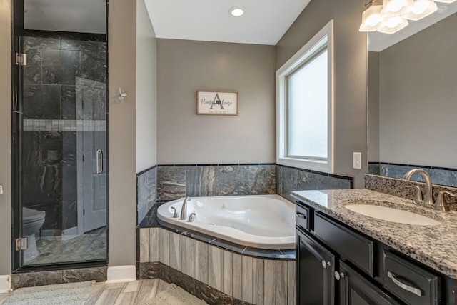 bathroom featuring vanity and independent shower and bath