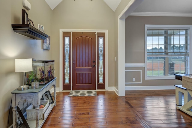 foyer with vaulted ceiling, ornamental molding, and dark hardwood / wood-style floors