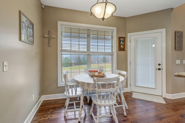 dining space with dark hardwood / wood-style floors