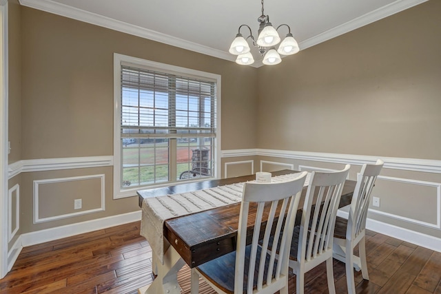 dining area with crown molding, dark wood-type flooring, and a notable chandelier