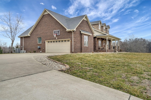 view of front of home featuring a garage, a front yard, and a porch