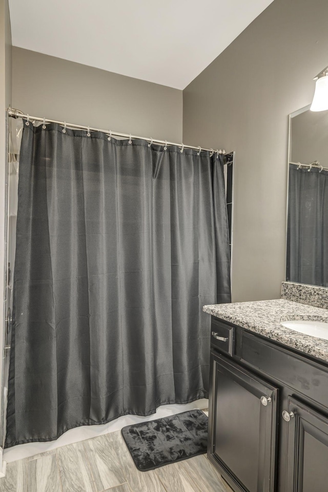 bathroom with vanity and wood-type flooring