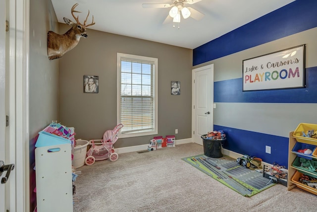 recreation room with carpet flooring and ceiling fan