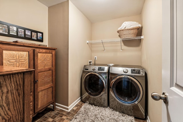 clothes washing area featuring washer and clothes dryer