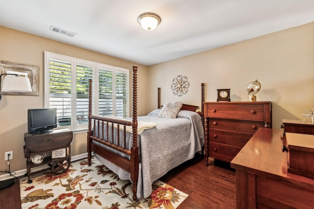 bedroom with dark wood-type flooring