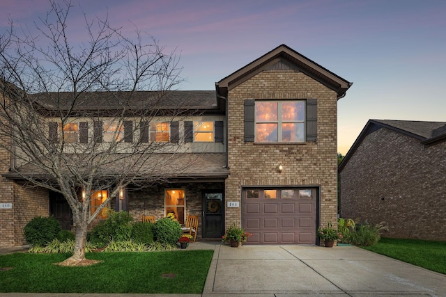 view of front of home with a garage and a lawn