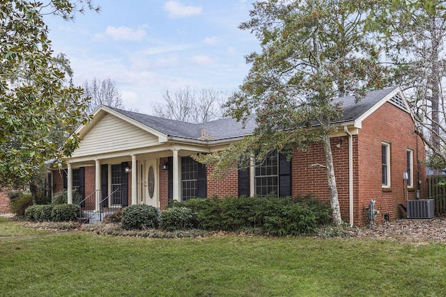 view of front facade with a front lawn and central air condition unit