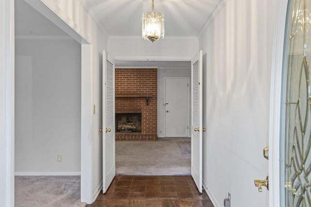 hall with dark parquet flooring, ornamental molding, and a chandelier