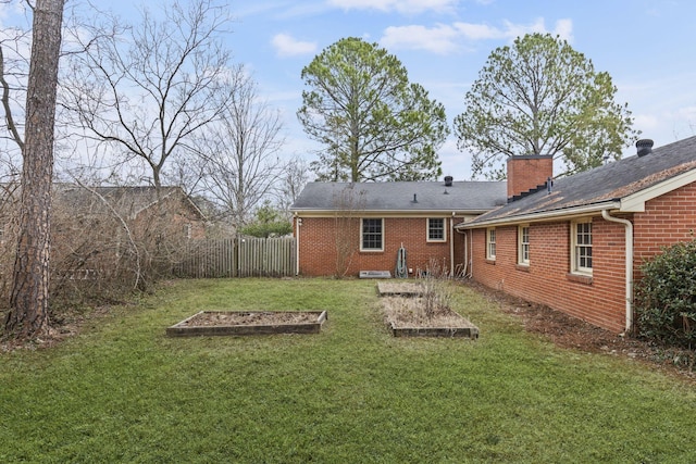 rear view of property featuring a lawn