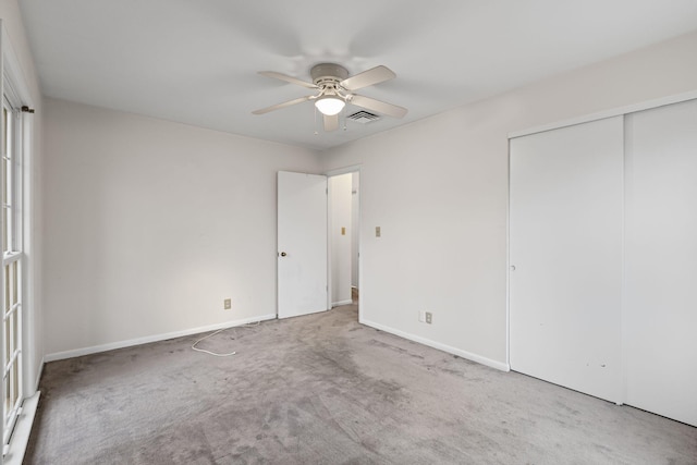 unfurnished bedroom featuring a closet, ceiling fan, and carpet flooring