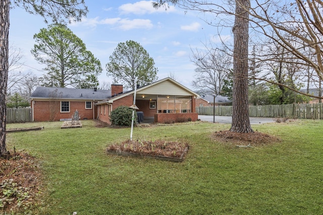 rear view of property with a yard