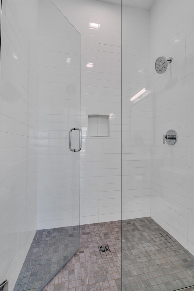 bathroom with a shower with shower door