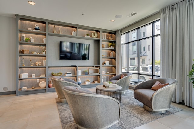 tiled living room featuring built in shelves