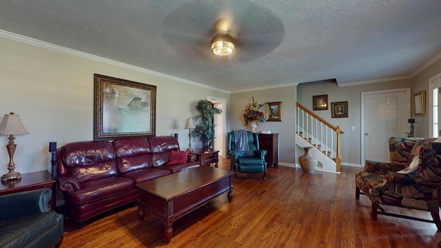 living room with crown molding, hardwood / wood-style flooring, and a textured ceiling