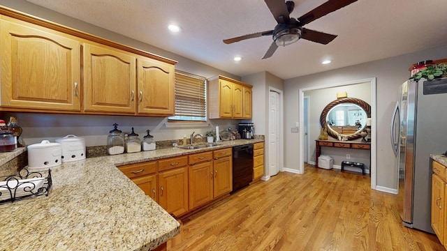 kitchen with stainless steel refrigerator, black dishwasher, sink, and light wood-type flooring