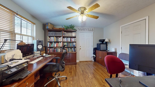 office area featuring ceiling fan, a textured ceiling, and light wood-type flooring